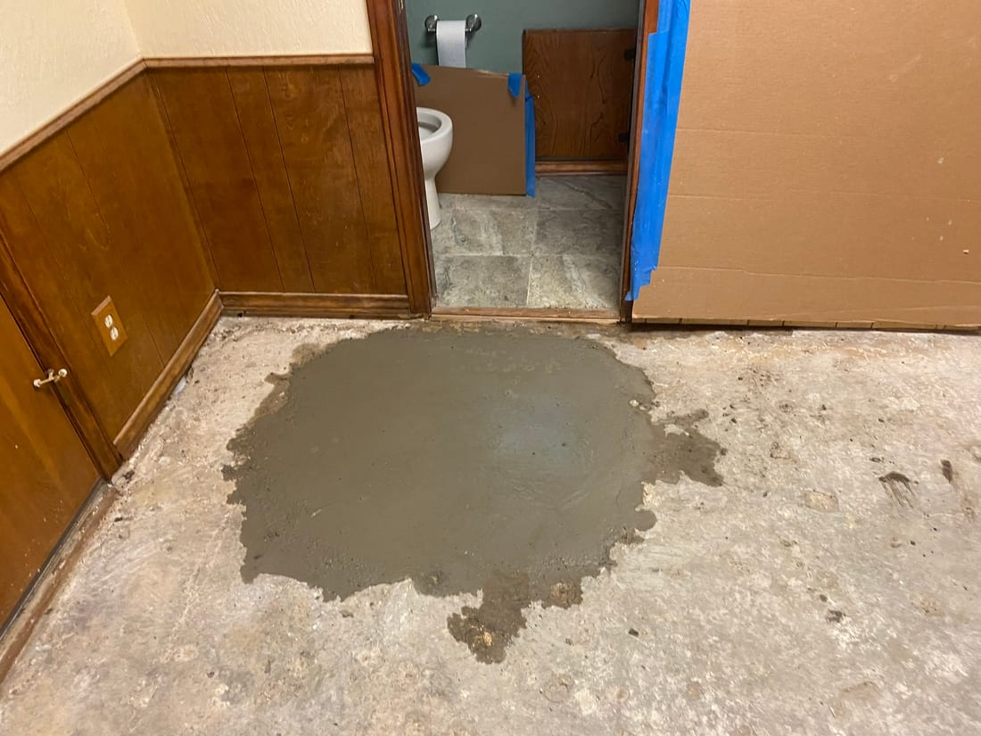 Fresh concrete sealing a finished slab-leak repair by Encore Plumbing