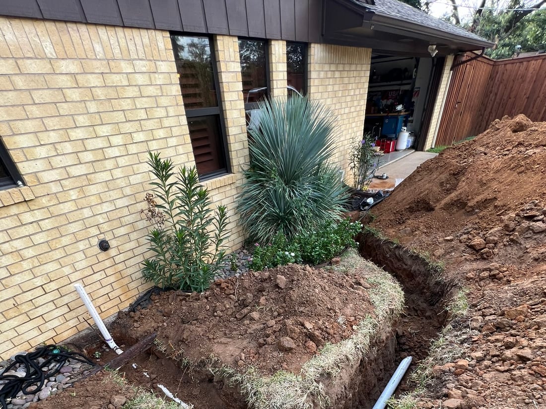 A new water line trenched beside landscaping by Encore Plumbing